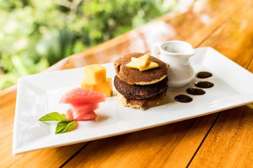 a white plate with desserts on a wooden table at Drake Bay Getaway Resort by Sandglass in Drake