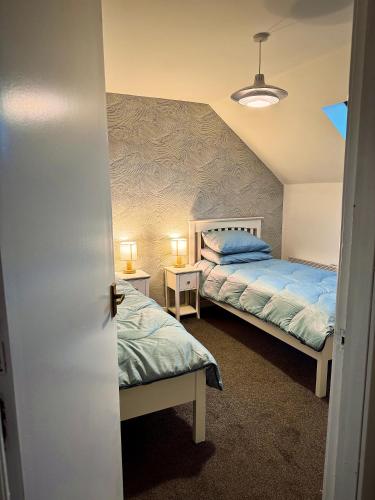 a bedroom with two beds in a room at Firth View, Burghead in Burghead