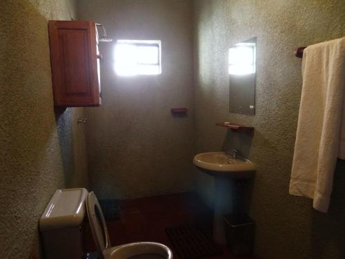 a small bathroom with a sink and a toilet at Ikweta Country Inn Maua in Kaathene