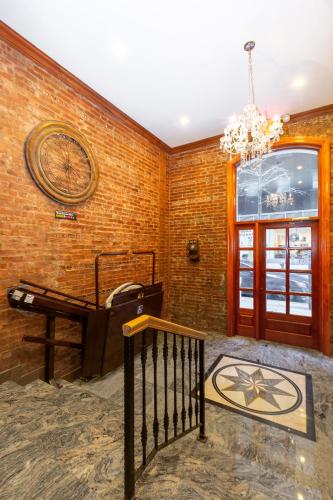 a room with a piano and a brick wall at Hotel St. James in New York