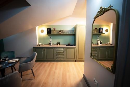 a bathroom with a vanity with a mirror and a chair at Tempus in Bucharest
