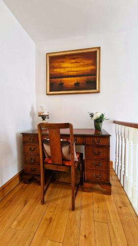 an office with a desk with a chair and a picture at The Three Musketeers, Aramis in Eastbourne