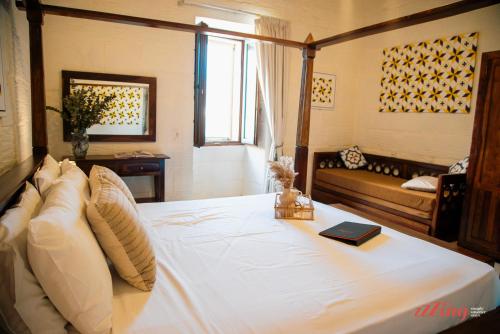 una camera da letto con un letto con un libro sopra di Gozo Dream with Heated Indoor Pool and an Outdoor Pool a Għarb