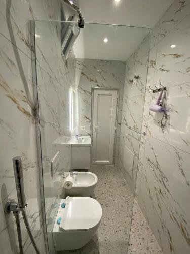 a bathroom with two toilets and a sink at Tirana Center Apartaments in Tirana