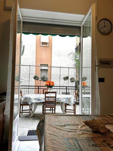 a room with a table and a view of a balcony at Casa di Francesca in Rapallo