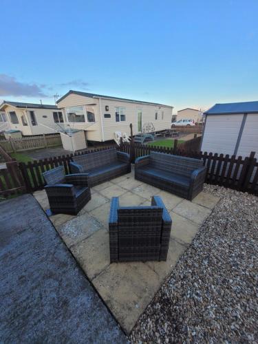 a group of benches in a yard with houses at 163 Holiday Resort Unity Brean - Centrally Located Pet Stays Free - Passes Included in Brean