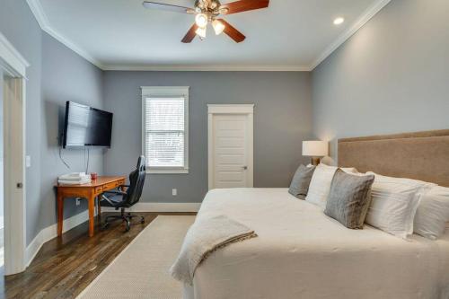 a bedroom with a bed with a ceiling fan and a desk at NEW 7 mins to Broadway Sleeps 8 in Nashville
