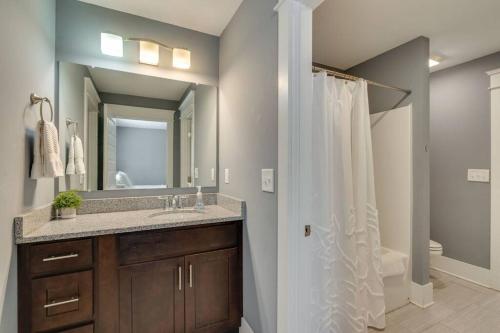 a bathroom with a sink and a shower with a mirror at NEW 7 mins to Broadway Sleeps 8 in Nashville
