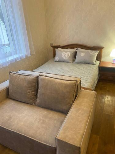 a bedroom with a bed with a bench next to it at Апартаменты ул.Антоновича in Lviv