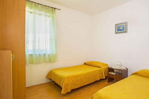 a room with two beds and a window at House ALANIS wtih sea view in quiet location in Ravni