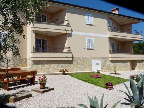a house with a bench in front of it at House ALANIS wtih sea view in quiet location in Ravni