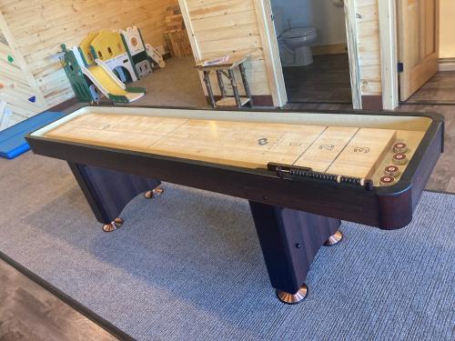 a ping pong table sitting in a room with at Keweenaw Waters Resort in Houghton
