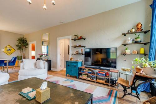 a living room with a flat screen tv and a couch at Historic East Nash Sleeps 6 in Nashville