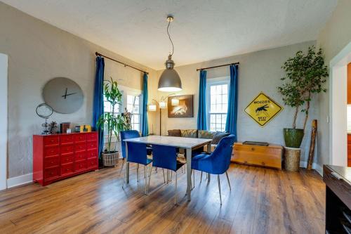 a living room with a table and blue chairs at Historic East Nash Sleeps 6 in Nashville