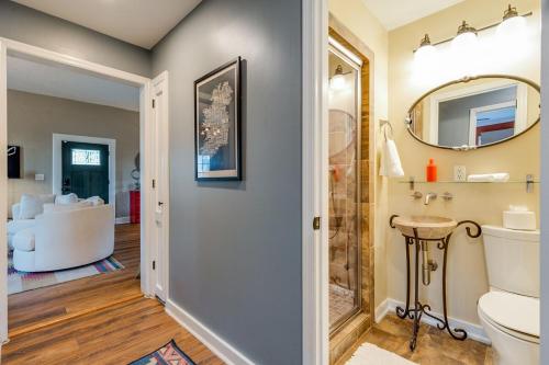 a bathroom with a toilet and a mirror at Historic East Nash Sleeps 6 in Nashville