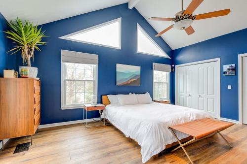 a blue bedroom with a bed and a ceiling fan at Historic East Nash Sleeps 6 in Nashville