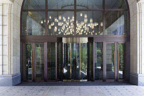 a large glass doorway to a building with a chandelier at Pullman Taiyuan in Taiyuan
