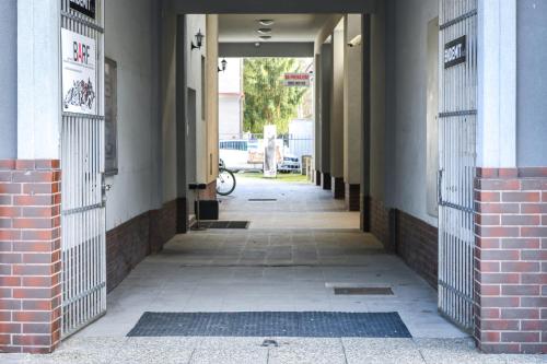 an empty hallway of a building with iron gates at Central Apartments in Martin
