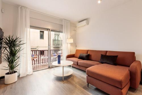 a living room with a couch and a table at Maria Poblenou Apartment by Olala Homes in Barcelona