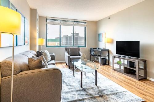 a living room with a couch and a tv at Modern & Spcaious Apt Near Downtown in White Plains