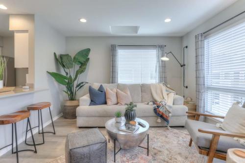 a living room with a couch and a table at Walk to Broadway Riverfront Condo with Pool in Nashville