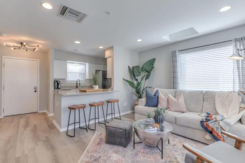 a living room with a couch and a kitchen at Walk to Broadway Riverfront Condo with Pool in Nashville