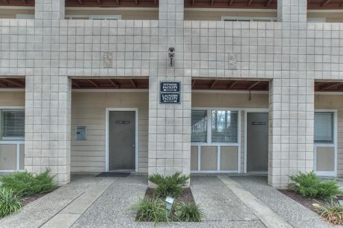 a building with two doors and a sign on it at Walk to Broadway Riverfront Condo with Pool in Nashville