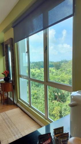 a room with a large window with a view at The Apartment at Santubong in Kuching