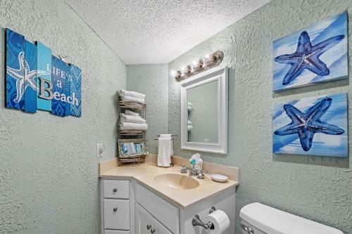 a bathroom with a sink and a mirror at 1238 Gulf Shores Plantation-West in Gulf Shores
