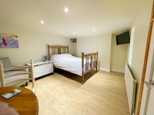 a small bedroom with a bed and a table at Ground floor basement apartment in Ebbw Vale in Ebbw Vale