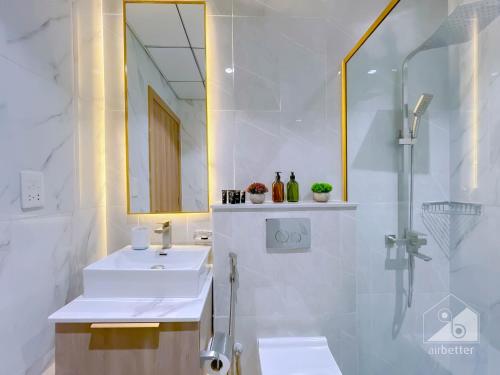 a bathroom with a sink and a shower with a mirror at NEW!Luxury 1B with balcony in Blue Wave Tower Dubai in Dubai