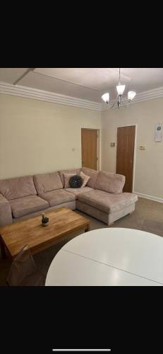 a living room with a couch and a coffee table at Double Room in a Cozy Apartment Dublin City Centre in Dublin