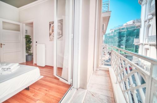 a room with a balcony with a view of the city at Apollonos apartment in Athens