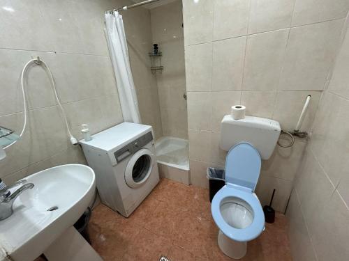 a bathroom with a toilet and a sink and a shower at Magheru City Center Studio in Bucharest
