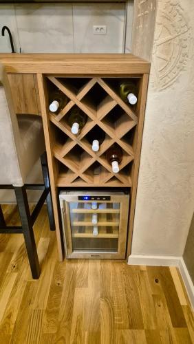 a wooden wine rack with wine bottles in it at PLAY APARTMAN VRSAC in Vršac