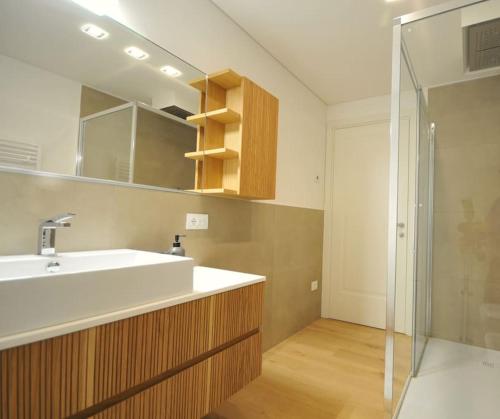 a bathroom with a sink and a shower at Domus Padova palazzo Roccabonella in Padova