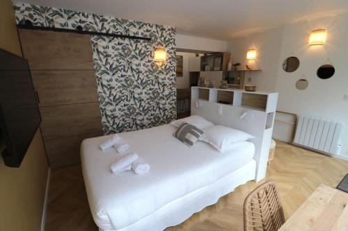 ein Schlafzimmer mit einem weißen Bett und Handtüchern darauf in der Unterkunft Cocon neuf & cosy - A deux pas de Bercy in Paris