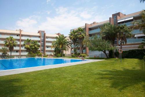 an apartment complex with a swimming pool in front of a building at Apto de diseño Salou-piscina gym in Salou