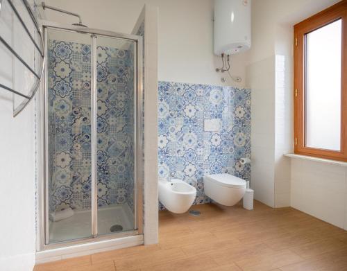 a bathroom with a shower and a tub and a toilet at Sorrento Coast Relais in Meta