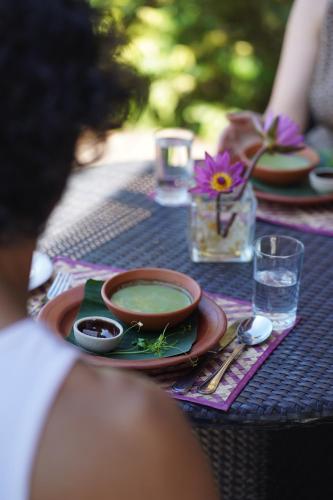 a table with a bowl of soup on a table at Treehouse Chalets - Luxury getaway within a short distance of Ella in Belihul Oya