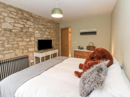 a bedroom with a large bed with a stone wall at 4 Castle Terrace in Barnard Castle