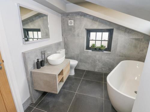 a bathroom with a sink and a tub and a toilet at 4 Castle Terrace in Barnard Castle