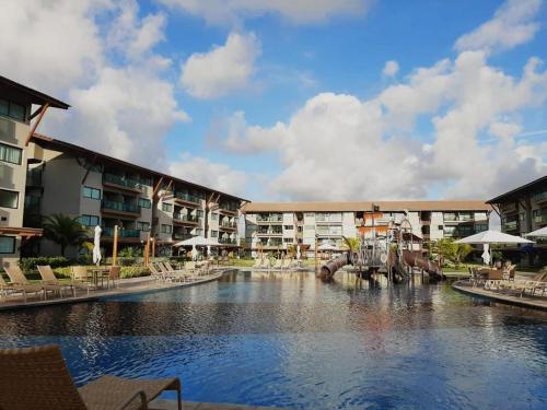 a resort with a pool with an elephant in the middle at Polinesia Resort - Porto de Galinhas - Apartamentos com somente 1 opção de Térreo com Piscina Privativa - Acesso ao Hotel Samoa in Porto De Galinhas