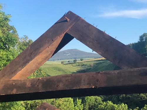 a wooden fence with a view of a mountain at BASALTE in Saint-Front