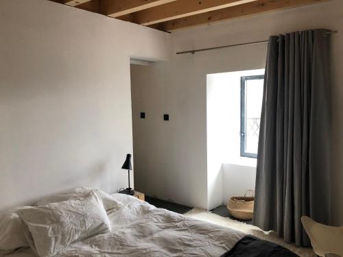 a bedroom with a bed and a window at BASALTE in Saint-Front