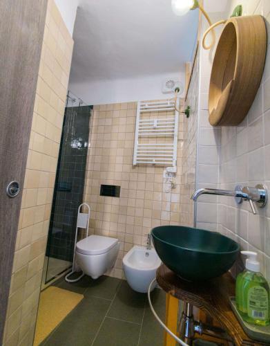 a bathroom with a sink and a toilet at La casetta del prato in Iesi