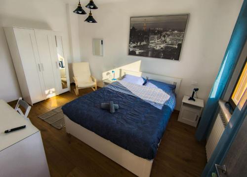 a bedroom with a bed with a blue comforter at La casetta del prato in Iesi