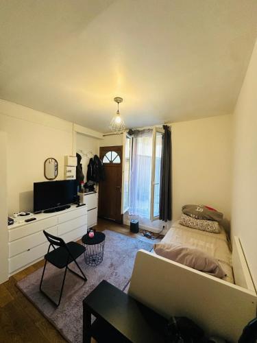 une chambre avec un lit et un canapé dans une pièce dans l'établissement Studio Agréable, à Issy-les-Moulineaux