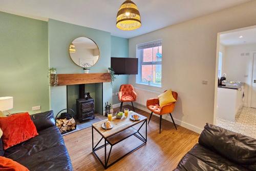 a living room with a couch and a table at Cosy yet spacious, 3BR, Parking, Village Location in Oswestry