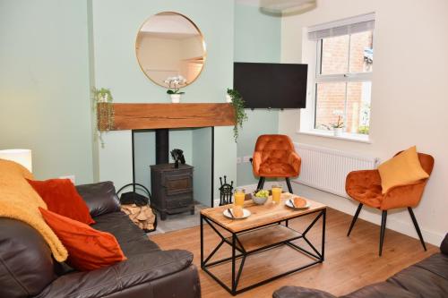 a living room with a couch and a fire place at Cosy yet spacious, 3BR, Parking, Village Location in Oswestry